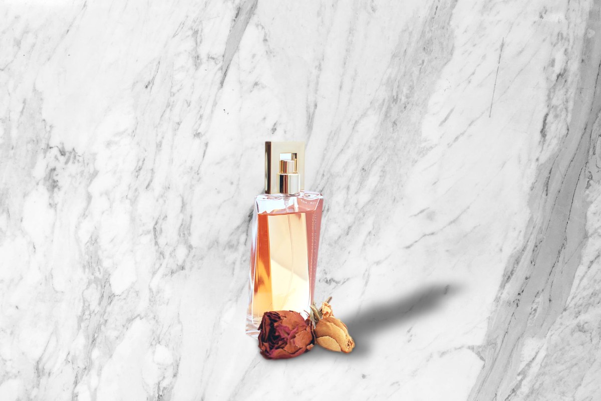 Glass perfume bottle on a marble scene