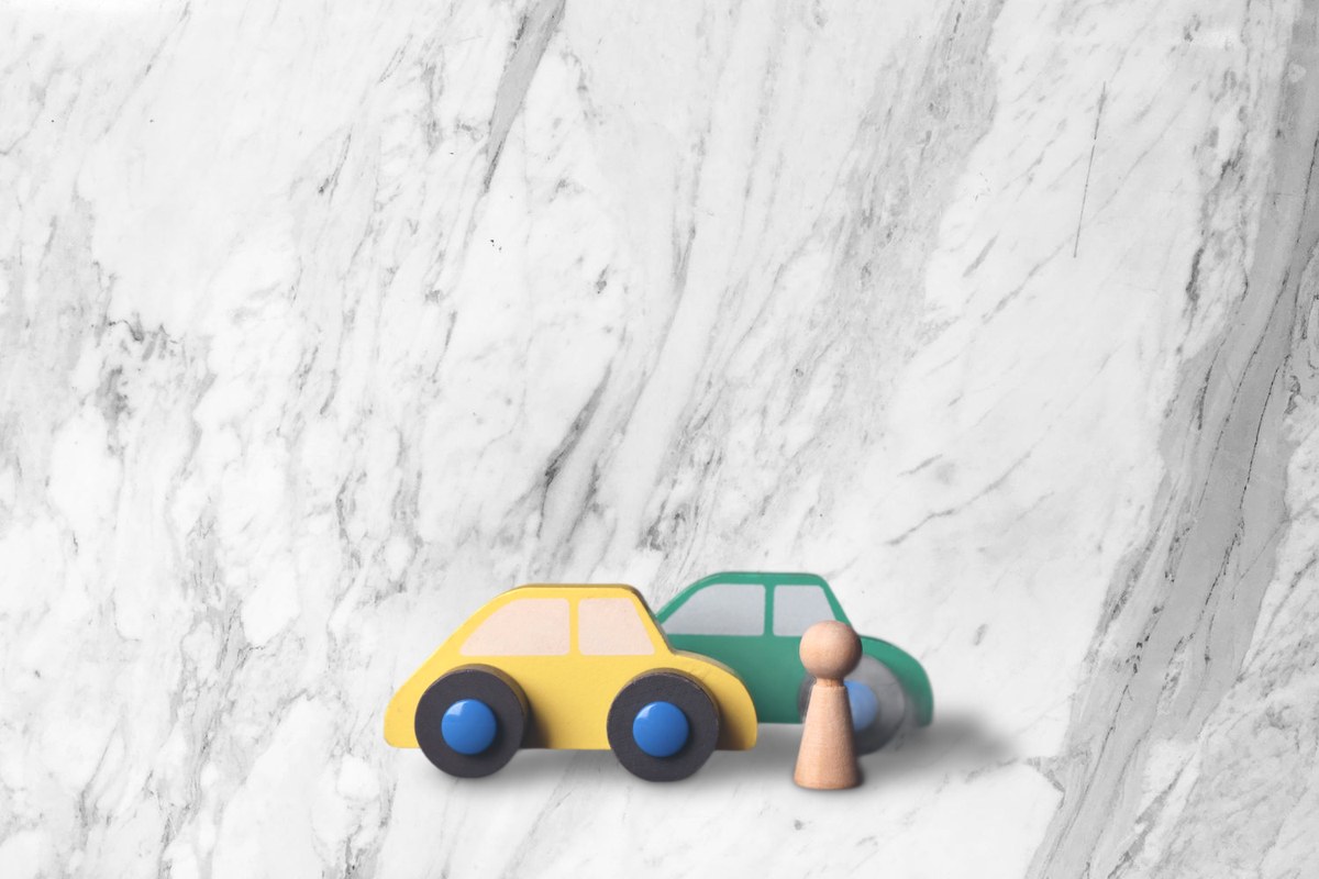 Wooden toy cars on a marble scene