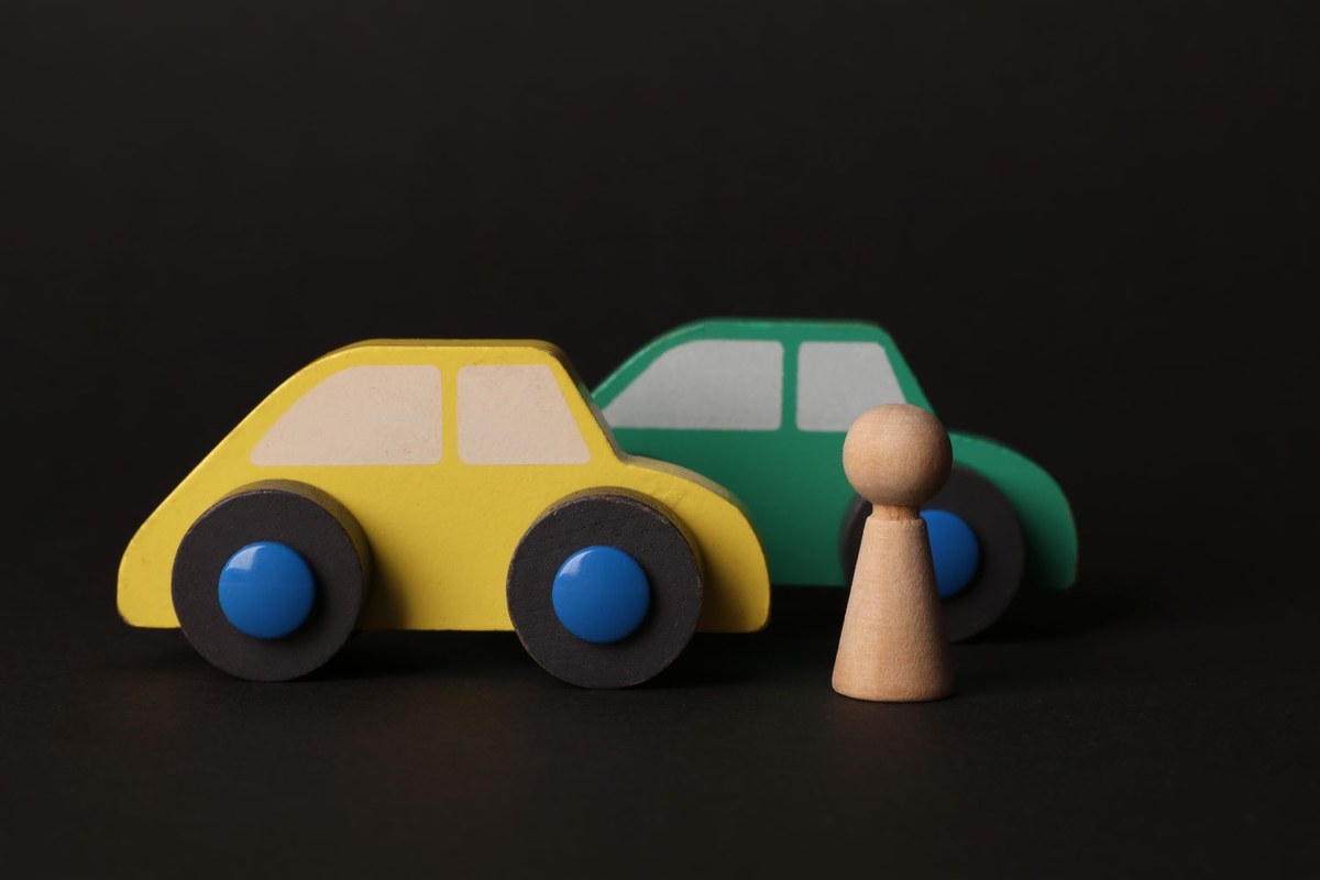 Original photo of wooden toy cars on a dark background
