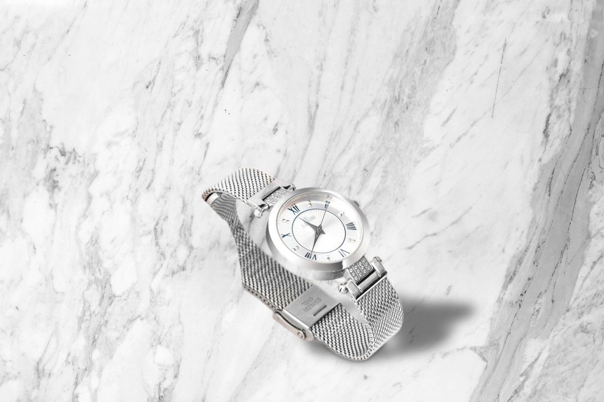 Steel watch on a marble scene