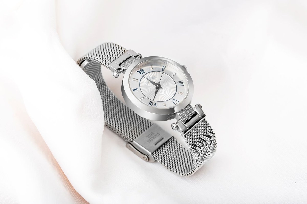 Original photo of a steel watch on fabric